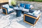 blue outdoor loveseat and armchairs for entertaining in a small backyard