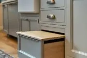 grey kitchen cabinetry with pull-out step stool in a drawer